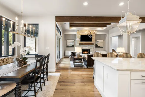a view of dining table chairs and kitchen