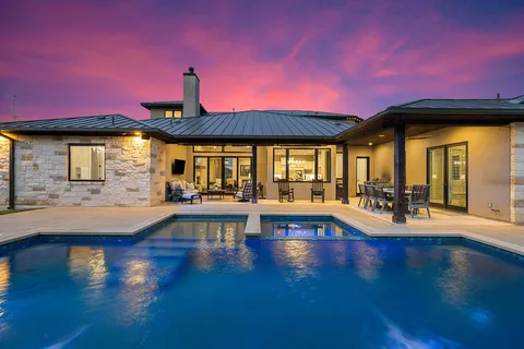 a view of a swimming pool with outdoor seating