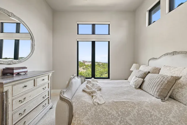 a bedroom with a large bed and a window