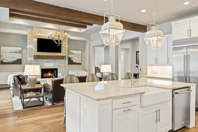 a view of living room and kitchen with furniture and a fireplace
