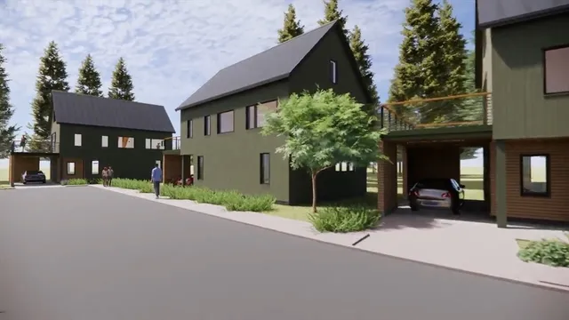 a view of a brick house with a yard and plants