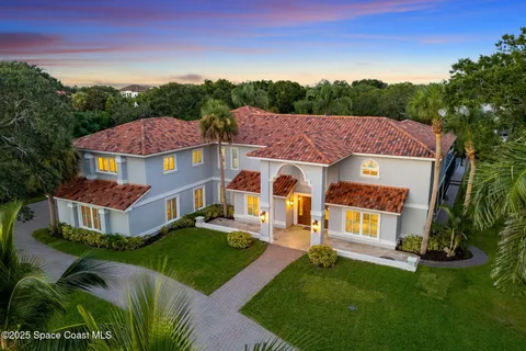 a view of a city with lots of residential buildings ocean and mountain view in back