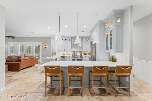 a living room with furniture a fireplace and a potted plant
