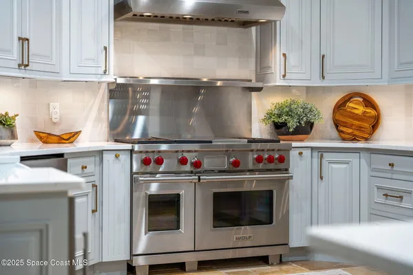 a living room with furniture a fireplace and a chandelier