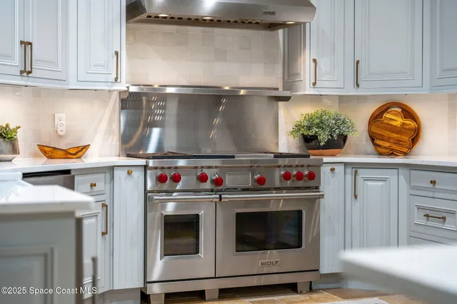 a living room with furniture a fireplace and a chandelier