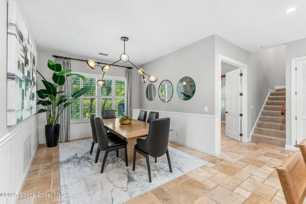 a living room with furniture a window and a flat screen tv