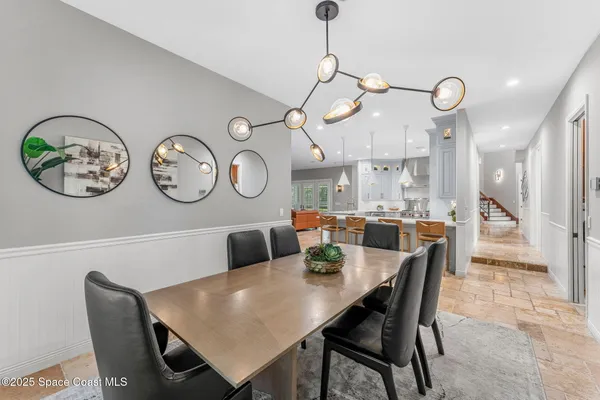 a living room with furniture a large window and a wooden floor