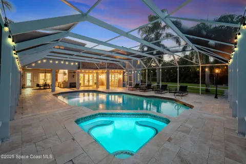 an aerial view of residential houses with outdoor space and trees