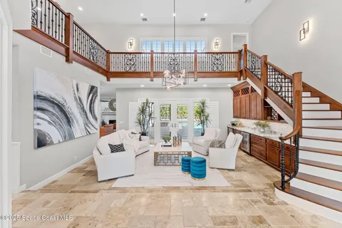 a living room with furniture and a chandelier
