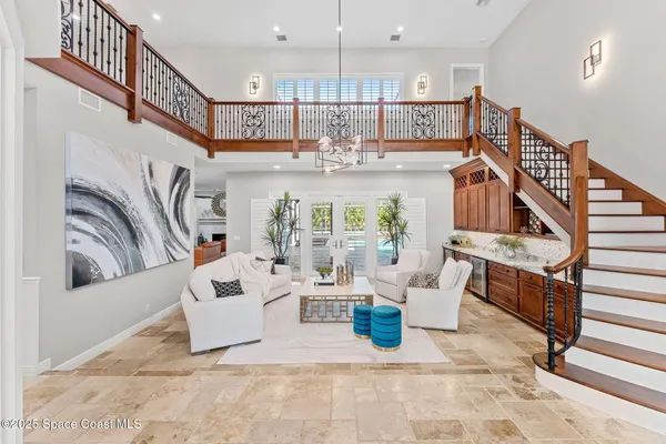 a living room with furniture and a chandelier