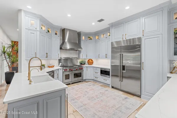 a utility room with stainless steel appliances and a sink