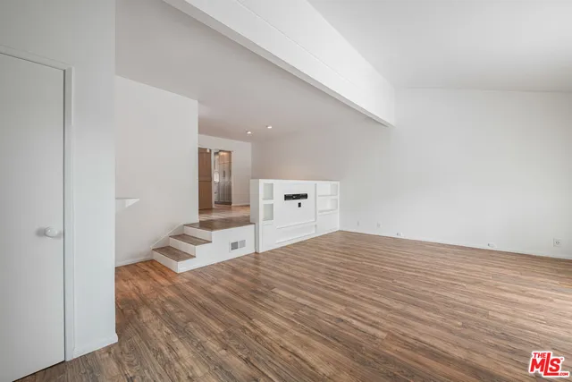 a bedroom with a bed and cabinets