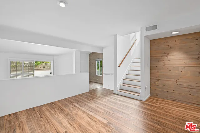a view of wooden floor and windows in a room
