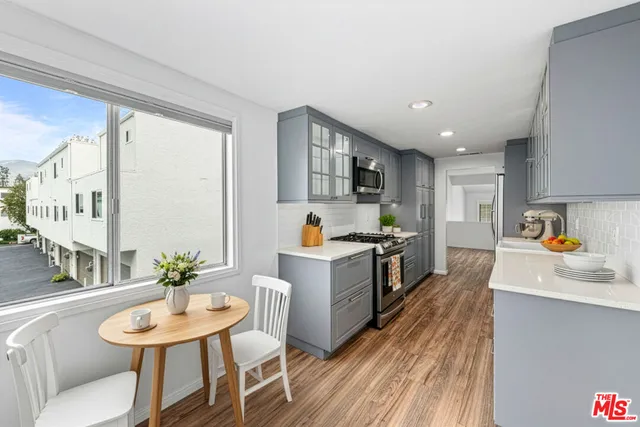 a kitchen with stove a sink and a refrigerator