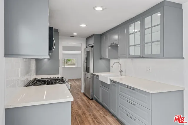 a kitchen with a sink stove and cabinets