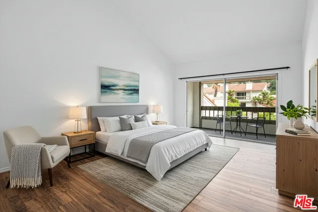 a bedroom with a large bed and a couch