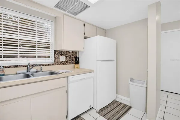 a kitchen with a sink and a refrigerator