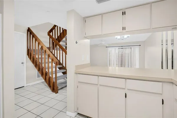 a view of staircase with white cabinets