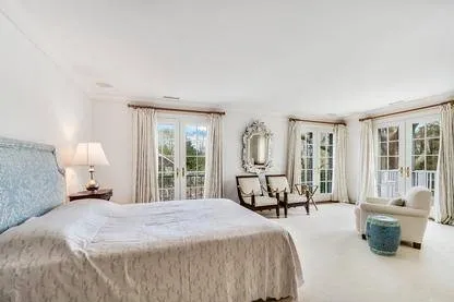 a bed room with a bed and a chair