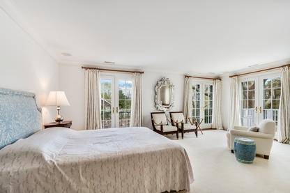 102 Georgica Road East Hampton, NY 11937 - Photo 13 of 17 a bed room with a bed and a chair