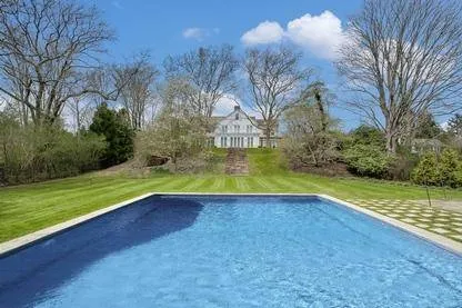 a view of a swimming pool and a yard