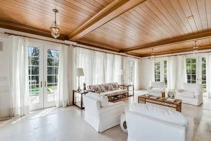 a living room with furniture windows and a table