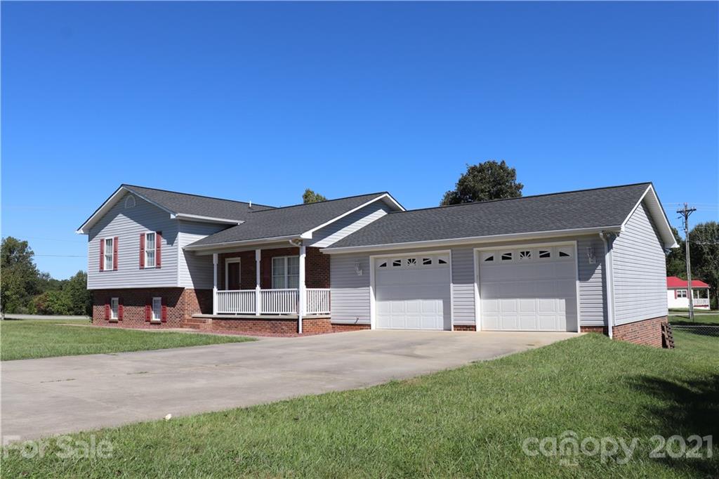 4120 Lower Cedar Valley Road Hudson, NC 28638 - Photo 1 of 48 a front view of a house with a yard and garage