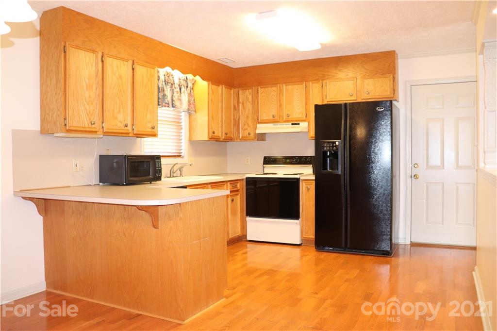 4120 Lower Cedar Valley Road Hudson, NC 28638 - Photo 11 of 48 a kitchen with stainless steel appliances a refrigerator sink and cabinets