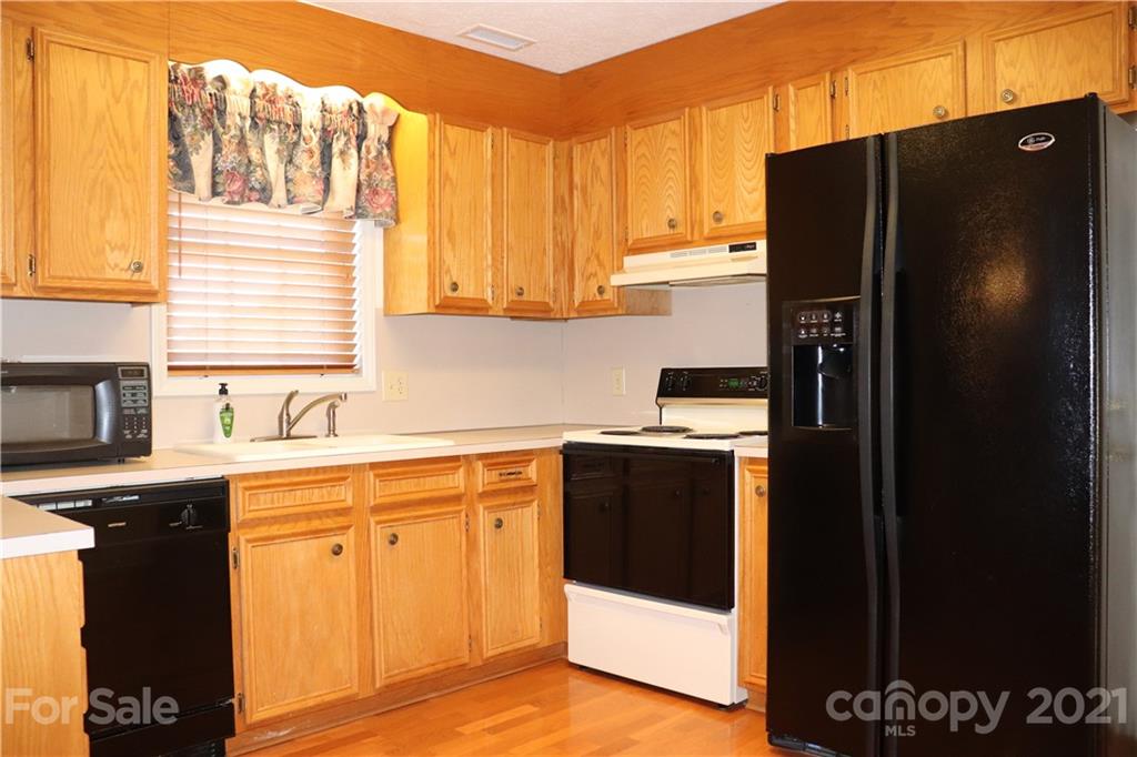 4120 Lower Cedar Valley Road Hudson, NC 28638 - Photo 12 of 48 a kitchen with a refrigerator and a sink