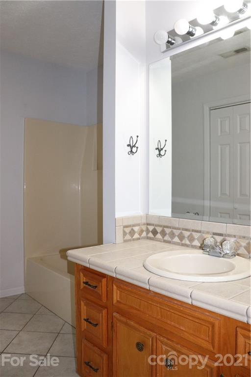 4120 Lower Cedar Valley Road Hudson, NC 28638 - Photo 22 of 48 a bathroom with a sink and a mirror