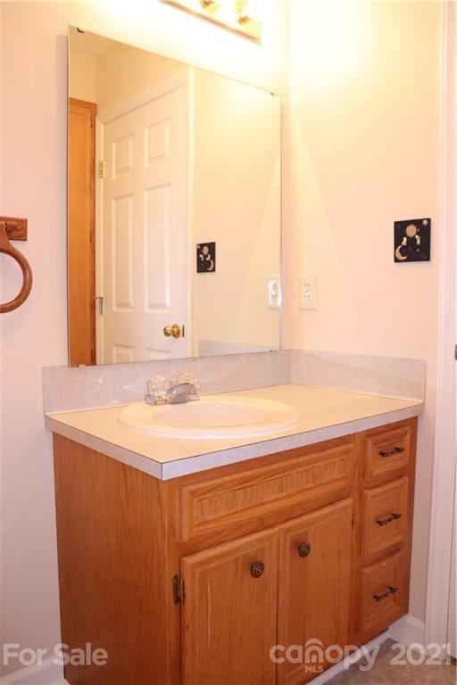 4120 Lower Cedar Valley Road Hudson, NC 28638 - Photo 32 of 48 a bathroom with a sink and a mirror