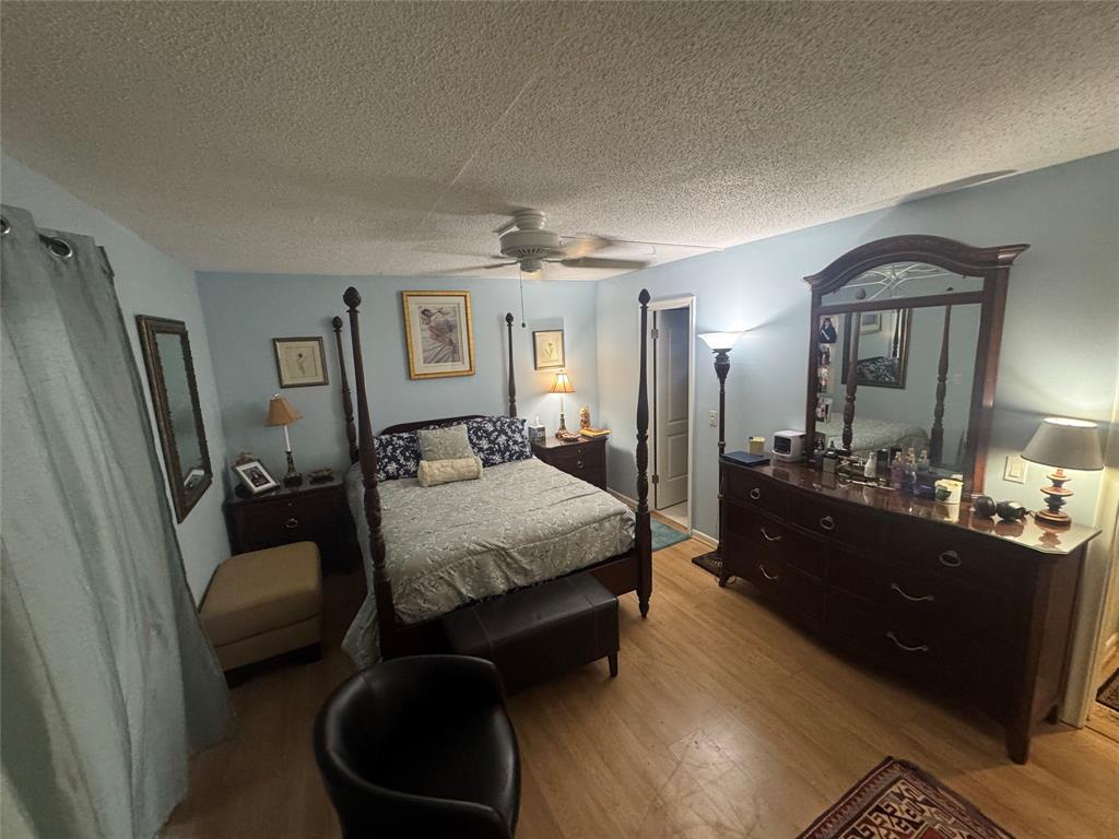 61 Camden C, Unit C West Palm Beach, FL 33417 - Photo 2 of 23 a bed room with a bed mirror and a dresser