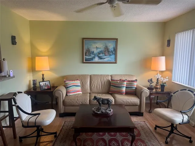 a living room with furniture and a lamp