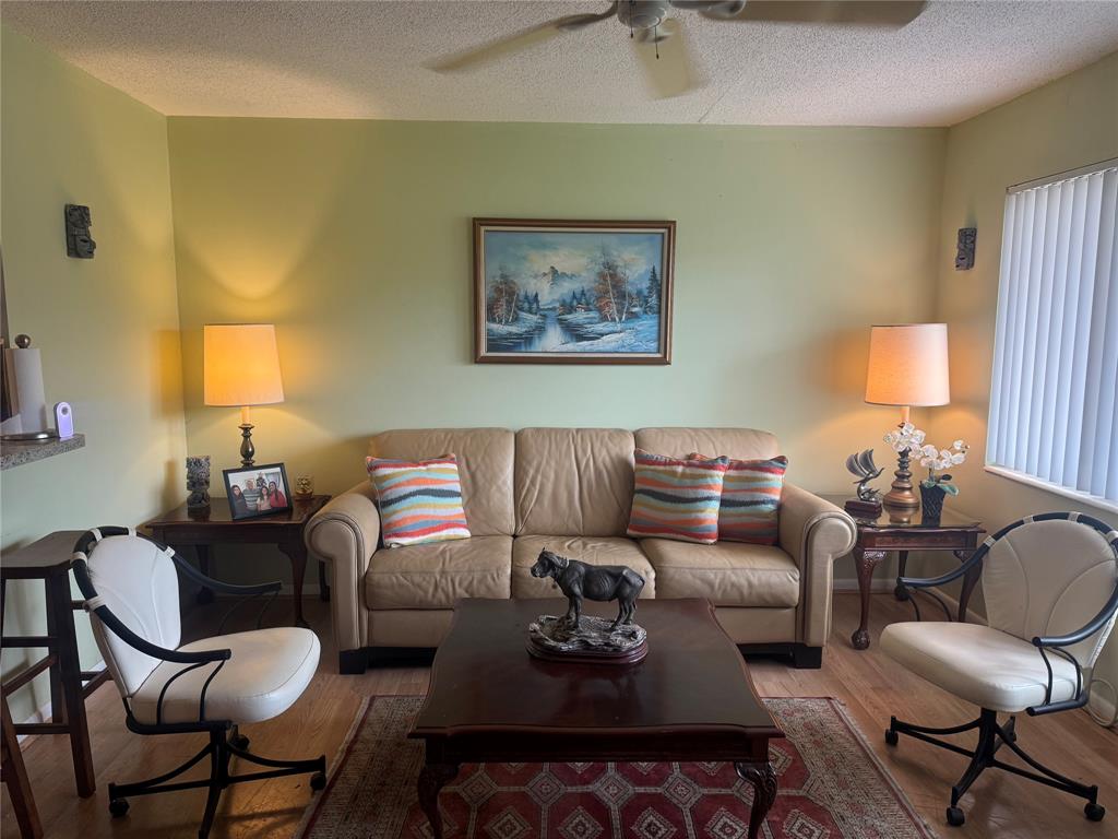 61 Camden C, Unit C West Palm Beach, FL 33417 - Photo 4 of 23 a living room with furniture and a lamp