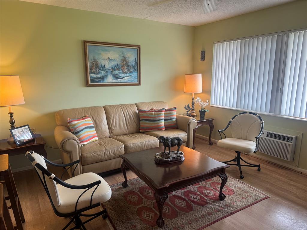 61 Camden C, Unit C West Palm Beach, FL 33417 - Photo 5 of 23 a living room with furniture a rug and a lamp