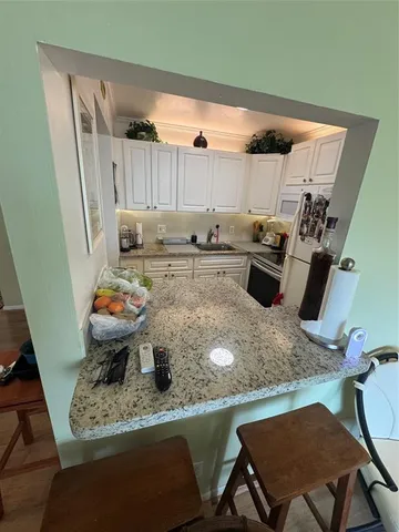 a view of a kitchen with sink and microwave