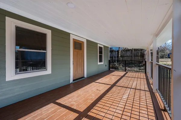 a area with wooden floor and balcony