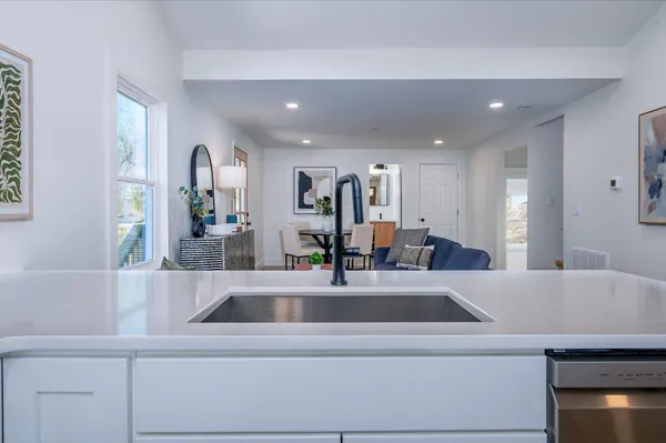 a kitchen with kitchen island a sink and a refrigerator