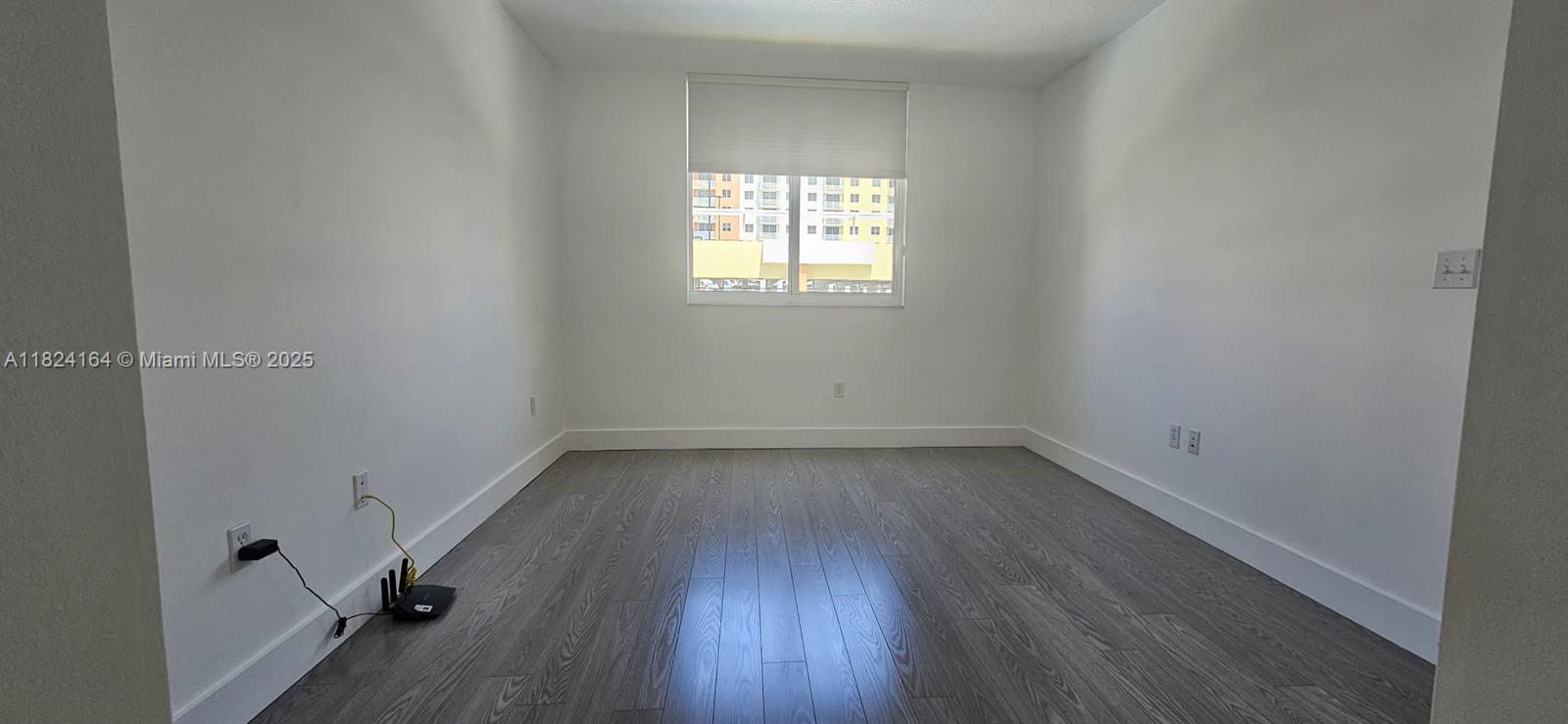 2775 Northeast 187th Street, Unit 424 Aventura, FL 33180 - Photo 11 of 16 wooden floor and window in an empty room