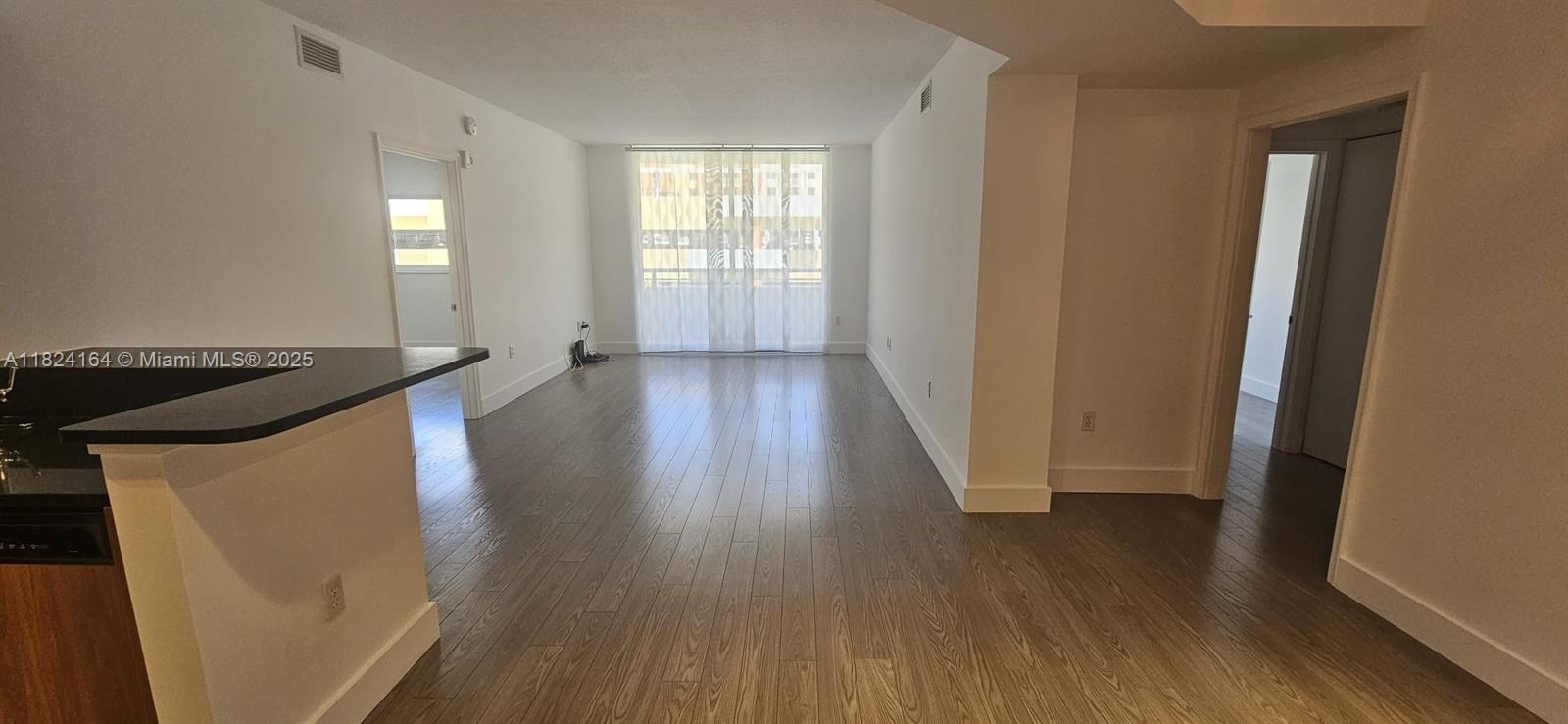 2775 Northeast 187th Street, Unit 424 Aventura, FL 33180 - Photo 3 of 16 wooden floor in an empty room with a window