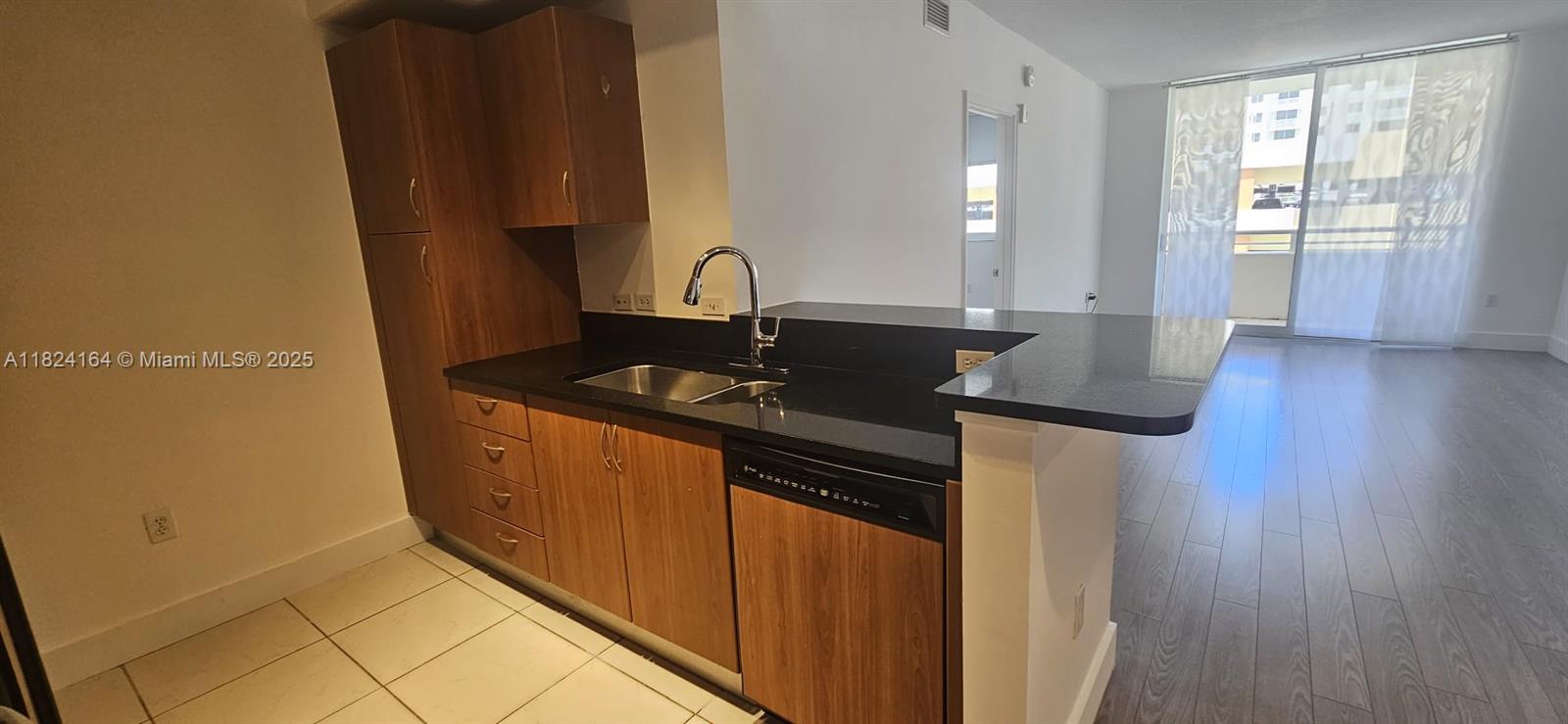 2775 Northeast 187th Street, Unit 424 Aventura, FL 33180 - Photo 4 of 16 a kitchen with granite countertop a sink and a stove