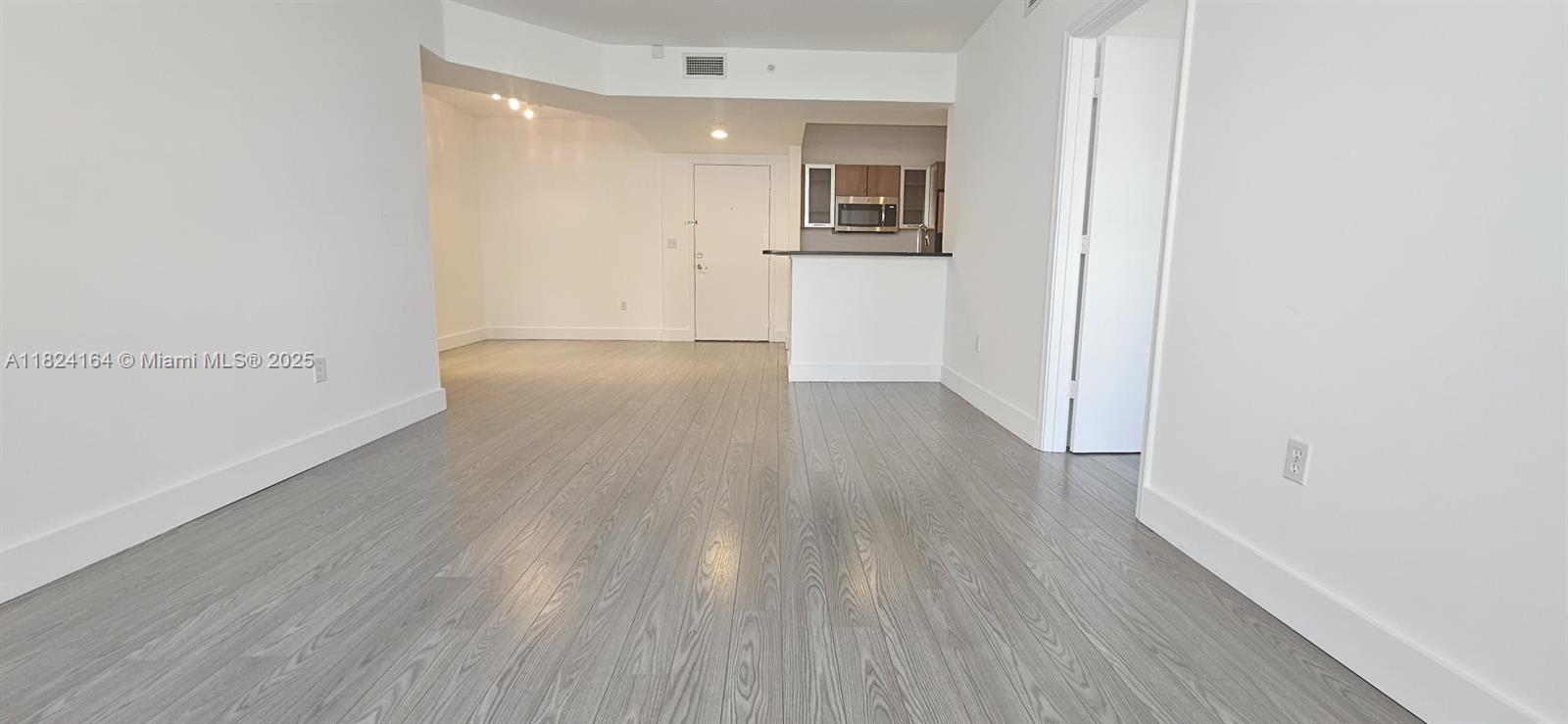 2775 Northeast 187th Street, Unit 424 Aventura, FL 33180 - Photo 6 of 16 a view of empty room with wooden floor