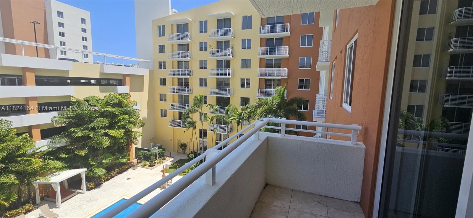 2775 Northeast 187th Street, Unit 424 Aventura, FL 33180 - Photo 8 of 16 a view of balcony with large windows and potted plants