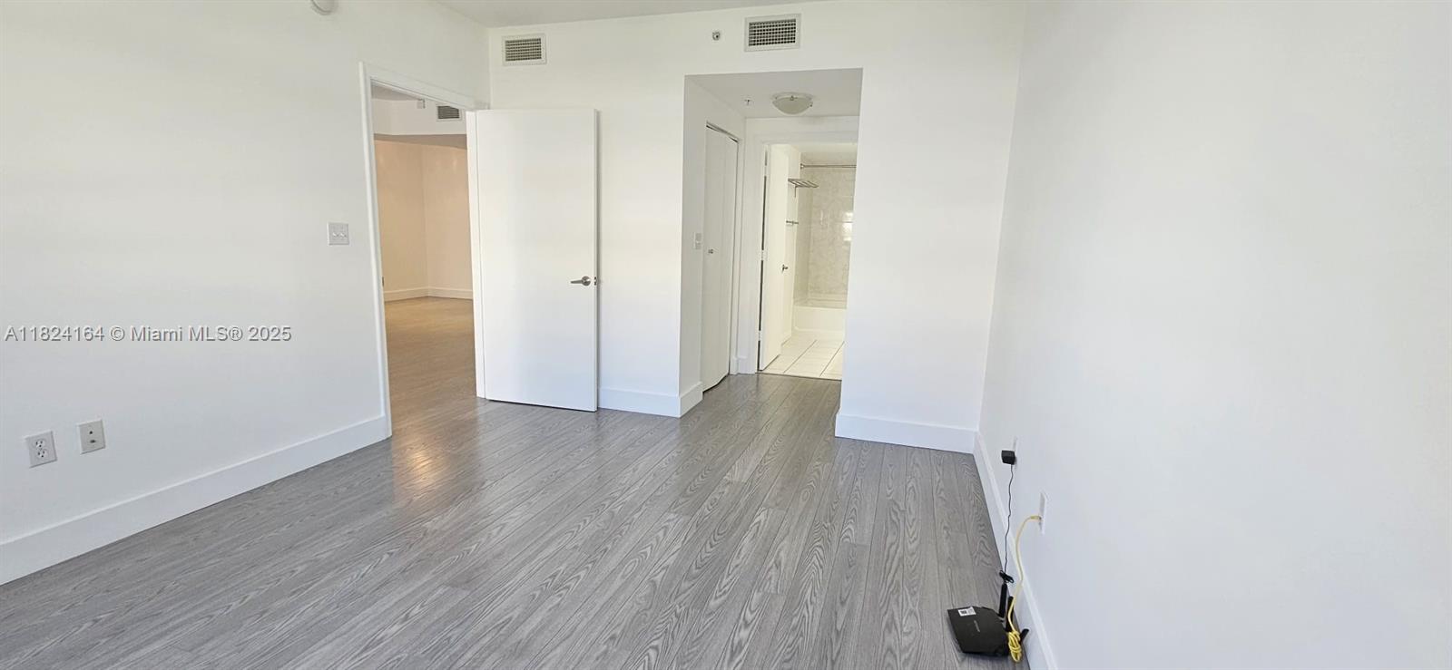 2775 Northeast 187th Street, Unit 424 Aventura, FL 33180 - Photo 10 of 16 a view of a hallway with wooden floor
