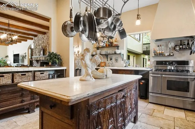 a kitchen with a kitchen island a stove and a table