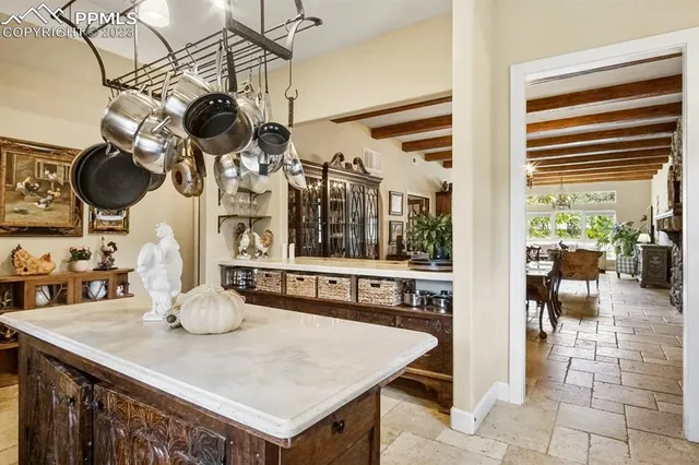 a kitchen with a table a stove and cabinets