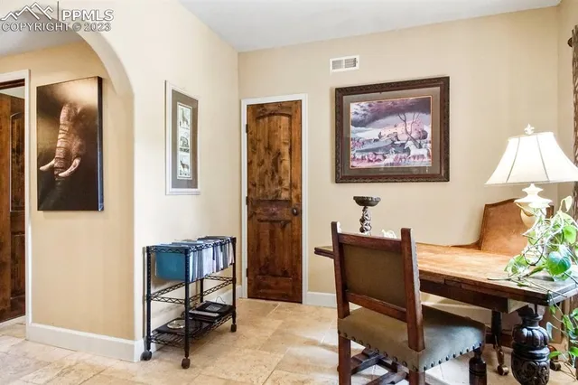 a view of a workspace with furniture and a window
