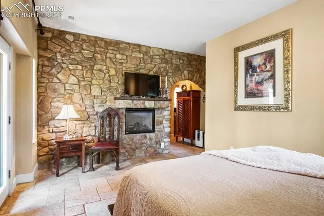 a bedroom with furniture and a flat screen tv