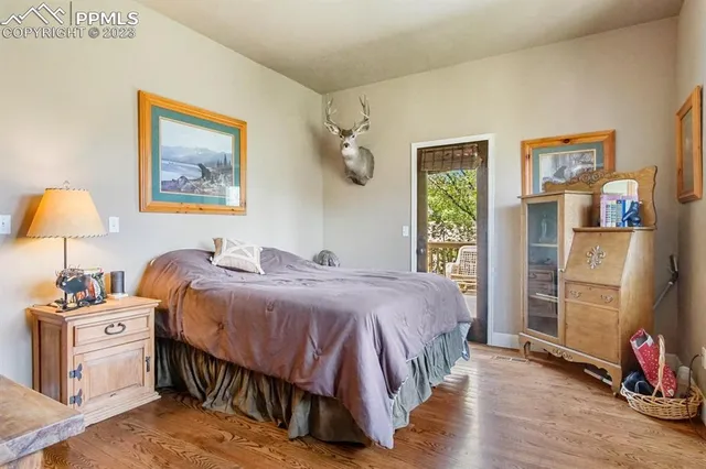 a bedroom with a bed and a lamp on the dresser