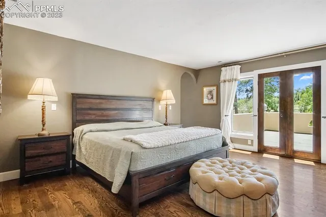 a bedroom with a bed and a large window